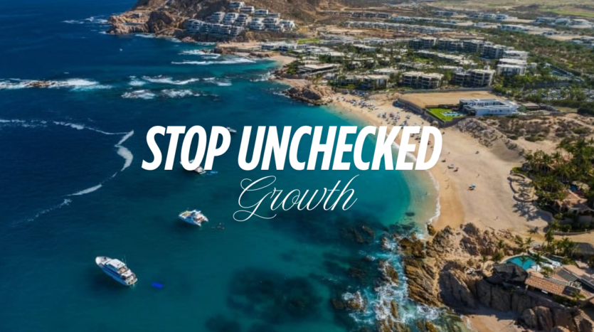 Low-rise terracotta luxury resorts along the Los Cabos coastline with desert mountains and Sea of Cortez representing the natural landscape that Los Cabos sustainable development must protect from unchecked vertical growth